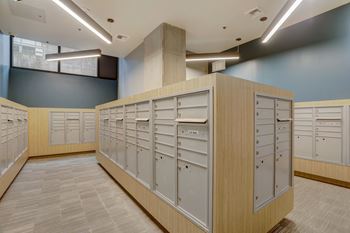 A row of lockers in a room with a tan floor.